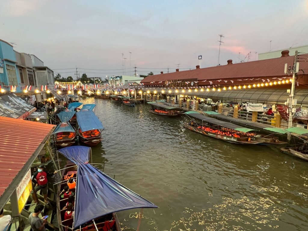 Bateaux colorés alignés sur les canaux du marché flottant d’Amphawa, offrant une ambiance unique. Marchés à ne pas manquer en Thaïlande